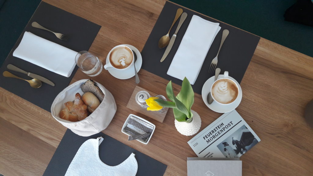 Gedeckter Fruehstuecksplatz mit Kaffee und Gebaeck