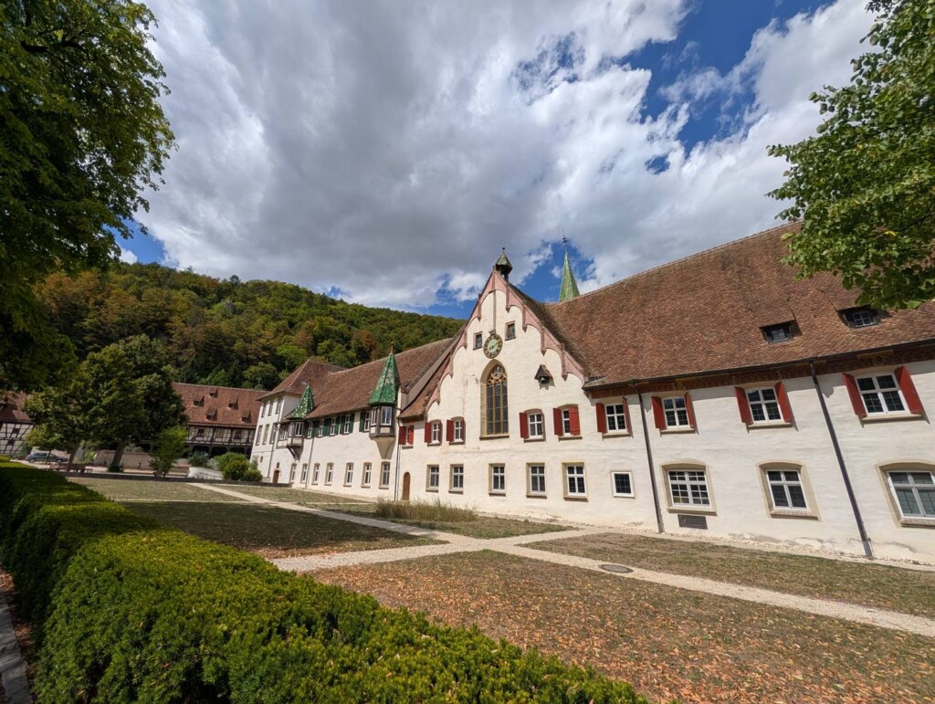 Innenhof des Klosters Blaubeuren mit Fachwerk, Erkern und grünen Turmspitzen